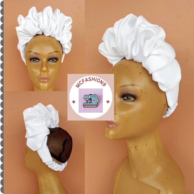 May include: White satin head wrap with a gathered design. The head wrap is worn on a mannequin head.