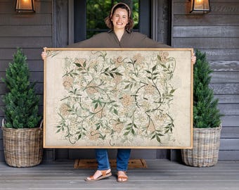 May include: A large rectangular framed wall art piece featuring a repeating botanical pattern of light beige flowers and dark green leaves on a cream-colored background. The artwork is enclosed in a simple, light-toned wooden frame.