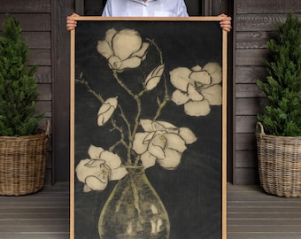 May include: A rectangular framed wall art piece featuring a charcoal-style illustration of white magnolia flowers in a glass vase against a dark black background. The artwork is encased in a light-toned wooden frame with a clean, simple border design.