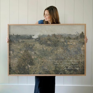 May include: A rectangular landscape painting in a light wood frame featuring a muted, earthy-toned scene of fields and trees under a cloudy sky. The text "Come to me, all who labor and are heavy laden, and I will give you rest. Matthew 11:28" is printed.