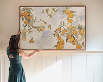 May include: A rectangular wall art piece in a dark wood frame featuring a botanical illustration of orange branches with green leaves and yellow-orange fruit against a light blue and white background, with handwritten script text in the center.