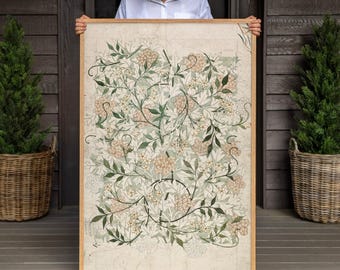 May include: A rectangular framed wall art piece featuring a botanical pattern with light green leaves and clusters of small, pale peach-colored flowers on a cream-colored background, enclosed within a simple, light-toned wooden frame.