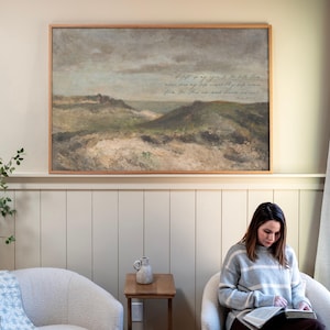 May include: A rectangular landscape painting in a light wood frame featuring rolling green hills under a cloudy sky. The artwork includes cursive text that reads: I lift up my eyes to the hills from where does my help come? My help comes from the Lord who made heaven and earth. Psalm 121:1-2.