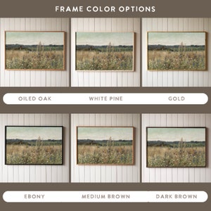 May include: Six different frame color options for a print of a landscape painting. The painting depicts a field of wildflowers with a small house in the distance. The frame colors are oiled oak, white pine, gold, ebony, medium brown, and dark brown.