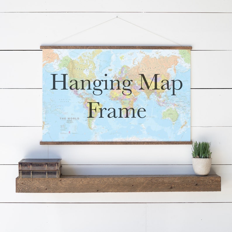Pu&ograve; includere: Uno scaffale in legno con una mappa del mondo appesa sopra in una cornice per mappe sospesa. La mappa &egrave; blu e ha bordi marroni. C'&egrave; una piccola pianta in vaso sullo scaffale.