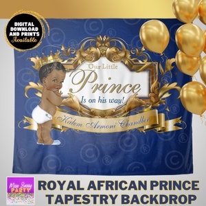 May include: A royal blue tapestry backdrop with gold accents featuring a cartoon illustration of a baby prince wearing a crown and a white diaper. The text "Our Little Prince Is on his way!" is written in gold lettering. The name "Kalem Armoni Chandler" is written below the text.