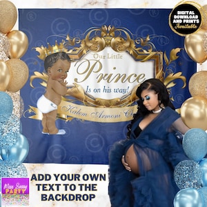 May include: A blue and gold baby shower backdrop with a crown, a baby boy illustration, and the text "Our Little Prince Is on his way!"  The backdrop is decorated with gold swirls and a gold frame.