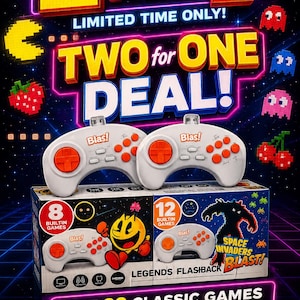 May include: Two white video game controllers with orange directional pads and buttons, labeled Blas!, resting on two game console boxes. One box features 8 built-in games and the other 12 built-in games, including Space Invaders Blast!.