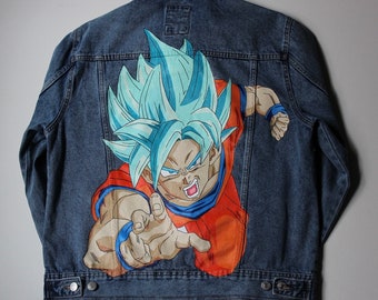 May include: A blue denim jacket with a hand-painted image of a blue-haired anime character with a red and orange outfit. The character is in a fighting pose with their fist extended forward.