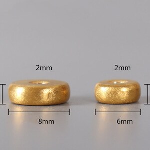 May include: Two gold-colored wooden rings, one measuring 2.5 inches in diameter and 8 mm in height, and the other measuring 2.5 inches in diameter and 6 mm in height.