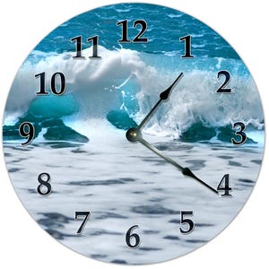 May include: A round clock with a blue and white ocean wave design. The clock face has black numbers 1 through 12 and black clock hands.