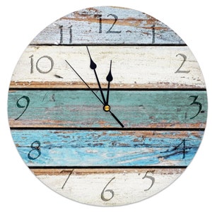 May include: A round clock with a distressed wood design in shades of blue, white, and brown. The clock face has black hands and white numbers.