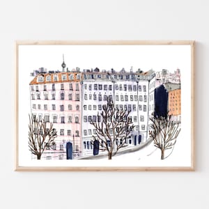 May include: A watercolor illustration of a city street scene with buildings and trees. The buildings are drawn in a simple style with pink and orange accents. The trees are bare and have black branches.