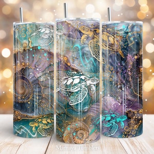May include: Three stainless steel tumblers with a teal, purple, and gold abstract design featuring white sea turtles. The tumblers have lids and straws. The text "Mamaya Tumblers" is at the bottom of the image.