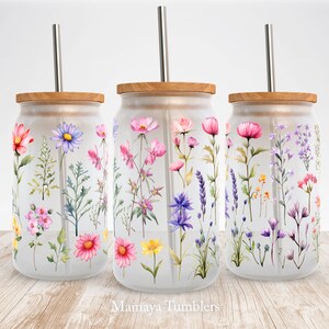 May include: Three glass tumblers with wooden lids and stainless steel straws. Each tumbler features a different watercolor floral design with pink, purple, yellow, and blue flowers.