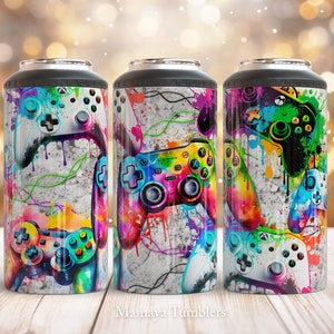 May include: Three insulated tumblers with a gaming theme. Each tumbler features a design of colorful video game controllers against a textured, gray background with paint splatter effects. The text "Mamaya Tumblers" is at the bottom.