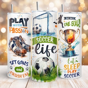 May include: Three stainless steel tumblers with watercolour designs featuring football imagery. The first tumbler has a football boot, a football, and the text "Play with Passion, Set Goals and Crush'em". The second tumbler has a football goal, a football, and the text "Soccer Life". The third tumbler has a football trophy, a football, and the text "One Shot One Goal, Eat Sleep Play Football".