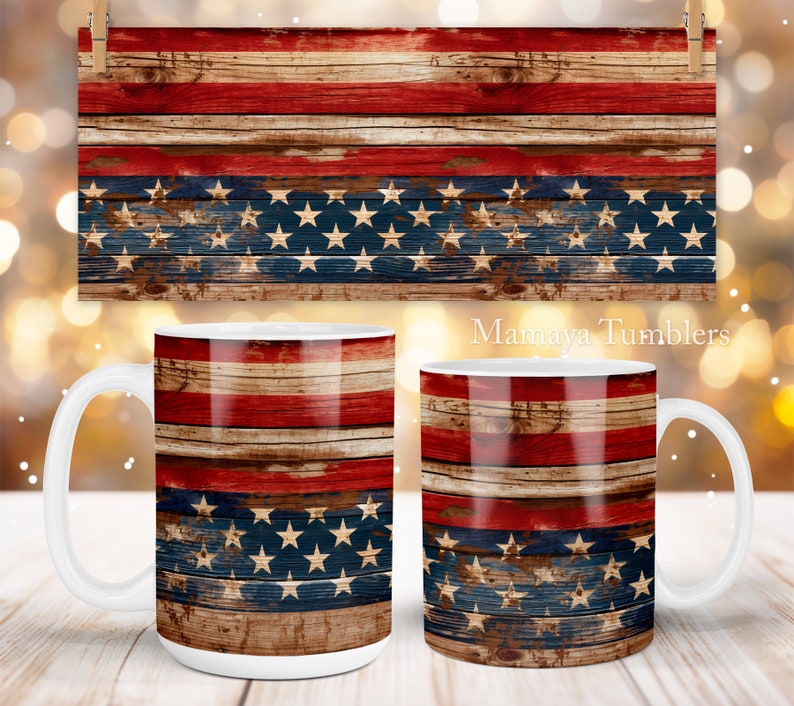 May include: Two white ceramic mugs with a wood grain design featuring the American flag colors of red, white, and blue. The mugs are on a wooden surface.  Mamaya Tumblers.