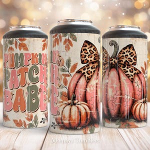 May include: Three insulated tumblers with an autumnal theme. The tumblers feature a pink pumpkin with a leopard print bow, a brown pumpkin with a green stem, and a white background with the text "Pumpkin Patch Babe".