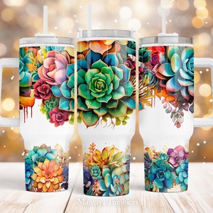 May include: Three white stainless steel tumblers with a colorful succulent design. The tumblers have a white lid and a white handle.