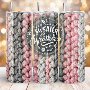 May include: Three stainless steel tumblers with a pink and gray knitted pattern. The center tumbler has a black and white graphic with the text "Sweater Weather".