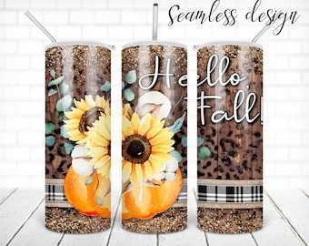May include: A stainless steel tumbler with a brown wood grain background, a black and white plaid ribbon, and a floral design featuring sunflowers, cotton, and a pumpkin. The text "Hello Fall!" is printed on the tumbler.