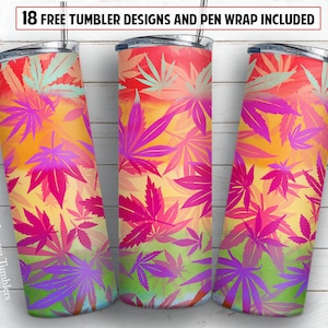 Könnte beinhalten: Drei Edelstahlbecher mit einem farbenfrohen Design aus rosa, lila, gelben und grünen Marihuana-Blättern. Die Becher stehen auf einem weißen Holzgrund. Der Text "Mamaya Tumblers" befindet sich auf dem linken Becher.