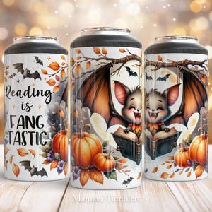 May include: A white tumbler with a black lid features a cartoon bat holding a book with the text "Reading is Fangtastic". The design also includes fall leaves, pumpkins, and bats.