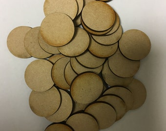 May include: A pile of round, unfinished wooden discs, perfect for crafting or painting. The discs are a light brown color and have a smooth surface.
