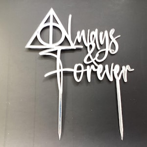 May include: Silver cake topper featuring a triangle symbol and the words "Always & Forever".