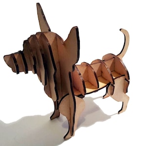 May include: A wooden model of a chihuahua dog, assembled in a layered style. The model is made of light brown wood and is standing on a white surface.
