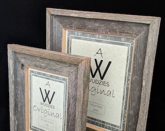 May include: Two rustic wooden picture frames, one 5x7 inches and the other 8x10 inches, with a weathered gray finish. Each frame has a light-colored inner border and a printed insert with the text "WUDZIES original".