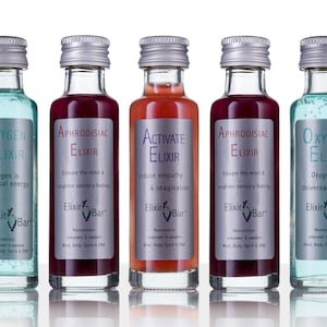 May include: Five small glass bottles with silver lids and labels. The labels are white with black text and feature the words "Oxygen Elixir", "Aphrodisiac Elixir", "Activate Elixir", "Aphrodisiac Elixir", and "Oxygen Elixir". The bottles are filled with different colored liquids: blue, red, pink, red, and blue.