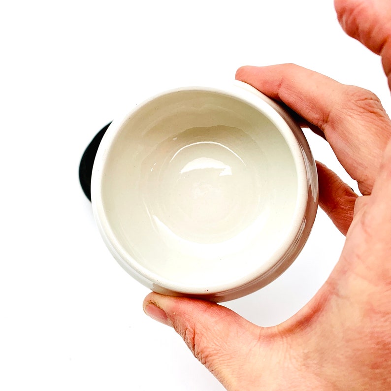 May include: A white ceramic bowl with a smooth, glossy finish. The bowl is empty and appears to be new.