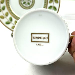 May include: White porcelain teacup with a gold rim and a gold logo that reads "Bernardaud Constance" on the bottom. The cup is marked with the number "520".