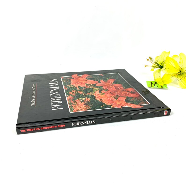 May include: A black hardcover book titled "The Time-Life Gardener's Guide: Perennials" with a close-up image of orange lilies on the cover.