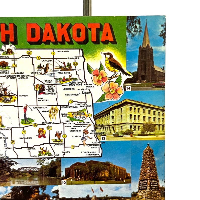 May include: A vintage postcard featuring a map of North Dakota with various cities and towns highlighted. The postcard also includes images of a church, a building, and a monument.
