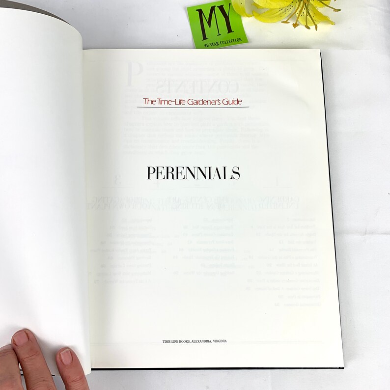 May include: An open book titled "Perennials: The Time-Life Gardener's Guide" with the word "Perennials" in bold text on the page. The book is published by Time-Life Books in Alexandria, Virginia.