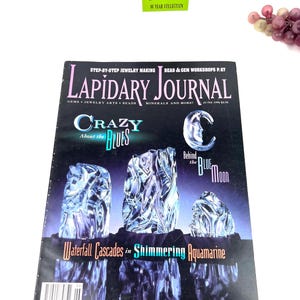 May include: A magazine cover for Lapidary Journal, featuring a blue and white gemstone with the text "Crazy Blues" and "Waterfall Cascades in Shimmering Aquamarine".