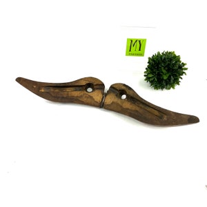May include: A wooden shoe last, a tool used by shoemakers to shape and form shoes, is shown in two pieces. The last is made of dark brown wood and has a smooth, polished finish. The two pieces are hinged together and can be adjusted to fit different shoe sizes.