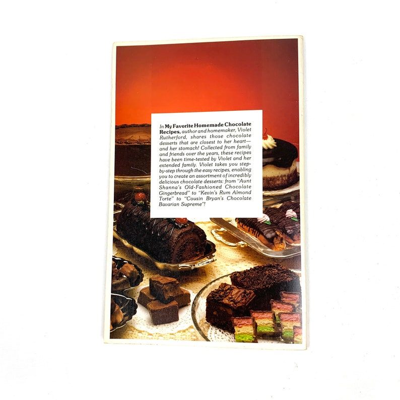 May include: A collection of chocolate desserts, including a chocolate roll, chocolate squares, and a layered chocolate cake. The image is from a cookbook titled "In My Favorite Homemade Chocolate Recipes".