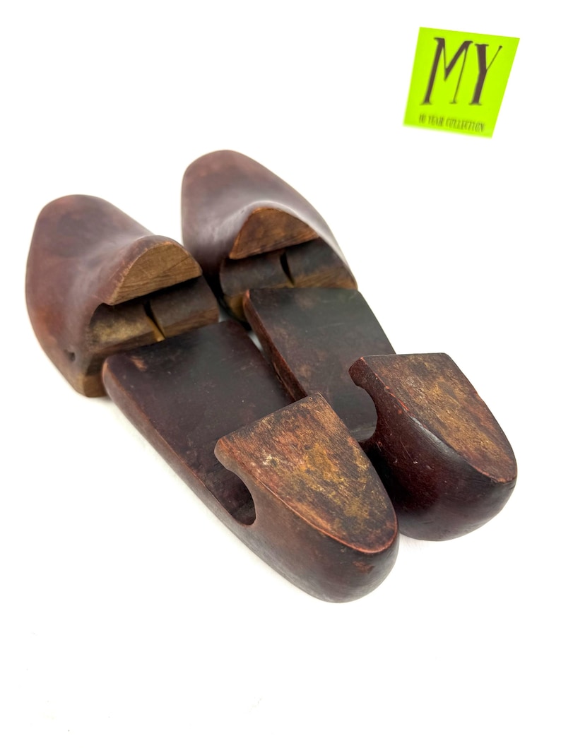 Pair of vintage wooden shoe stretchers angled with rich patina