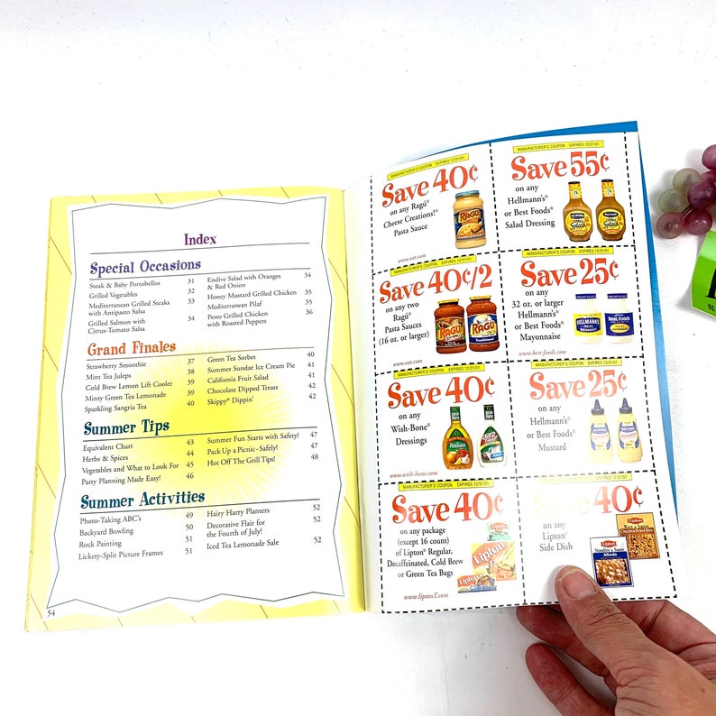 May include: A page from a cookbook with recipes and tips for summer entertaining. The page features a variety of coupons for food products, including Ragu pasta sauce, Wish-Bone salad dressings, Hellmann's mayonnaise, and Lipton tea.