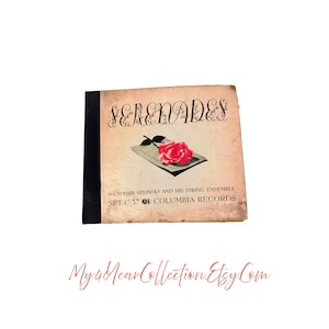 Op de afbeelding: Vintage vinylalbum getiteld "Serenades" van Wladimir Selinsky and His String Ensemble. De albumhoes toont een rode rozenillustratie. De plaat is een Columbia Records Set C-37.