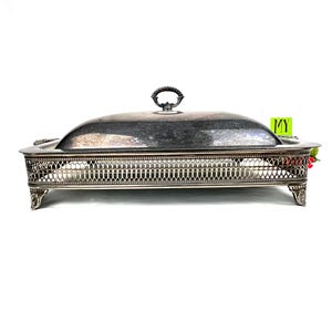 May include: Silver serving dish with a lid and a decorative, openwork base. The dish has a silver handle on the lid.