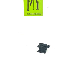 May include: A black metal miniature anvil with a small hammer on top. The anvil is sitting on a white surface.
