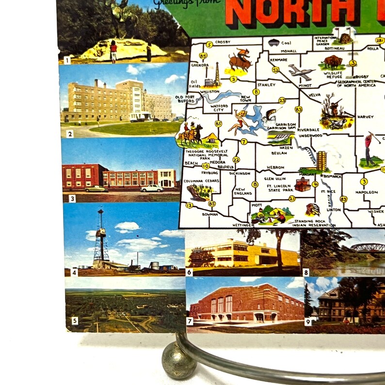 May include: A vintage postcard featuring a map of North Dakota with various images of landmarks and attractions. The postcard is divided into nine sections, each showcasing a different location. The map highlights cities like Williston, Minot, Dickinson, and Bismarck. The images include a building, a oil rig, a landscape, a school, and a bridge.