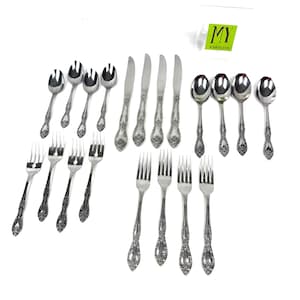 May include: A set of vintage cutlery, comprising spoons, forks, and knives, displayed on a white background. The silverware has decorative floral patterns on the handles. The image includes the text "MY" in a green rectangle.