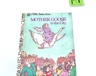 May include: A Little Golden Book titled "Mother Goose in the City". The cover features a white goose flying over a city with a girl in a purple dress and a pink scarf riding on its back. The city is depicted with brown buildings and a crowd of people looking up at the goose.