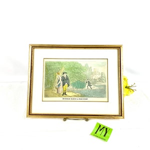 Peut inclure: Une estampe ancienne encadrée représentant une illustration humoristique d'un homme et d'une femme dans un paysage. L'estampe est intitulée "Dr Syntax Making a Discovery."